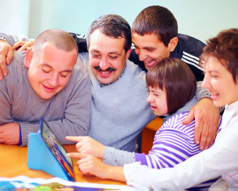 happy people having fun looking at photos