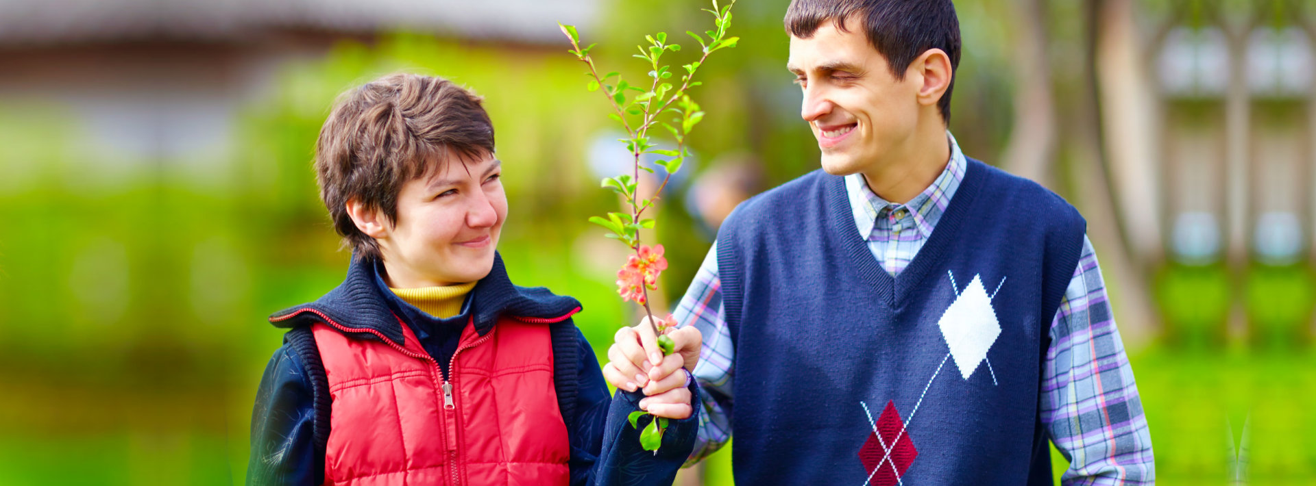 couple holding out a plant