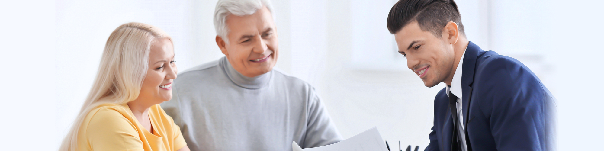 elderly couple meeting with counselor in office